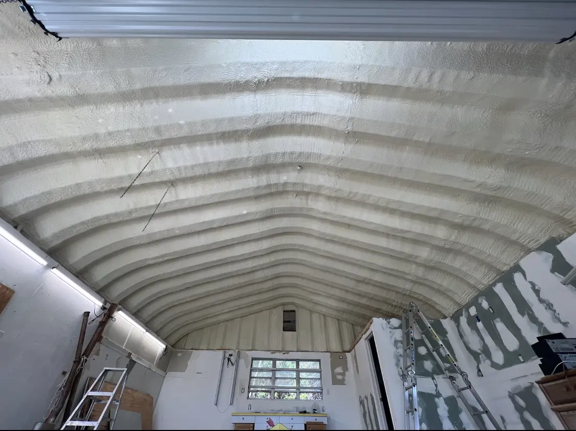 Spray polyurethane foam applied to the underside of a metal roof deck in Loxley